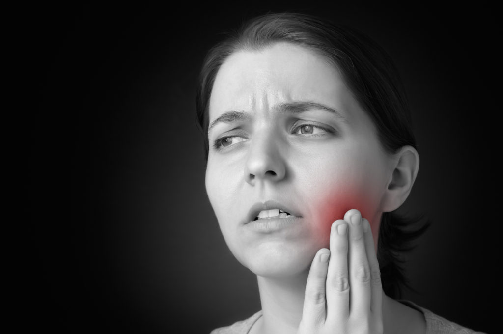 Young woman having toothache